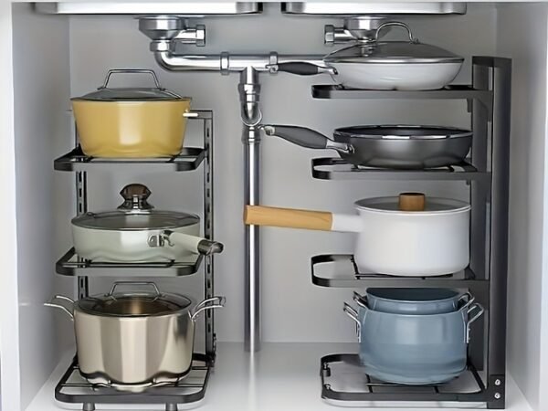 A multi-layer stainless steel pot rack organizer standing on a kitchen counter, holding various pots and pans neatly.