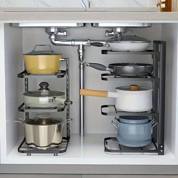 A multi-layer stainless steel pot rack organizer standing on a kitchen counter, holding various pots and pans neatly.