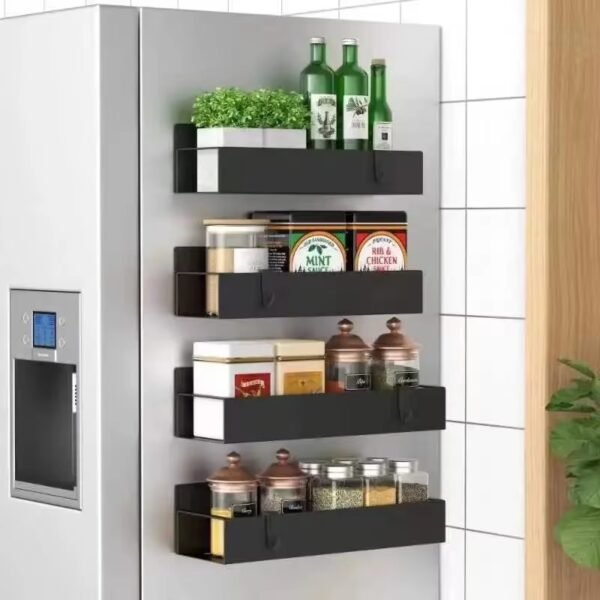 A heavy-duty, black magnetic refrigerator shelf holding several full spice jars and a bottle of olive oil on the side of a fridge.