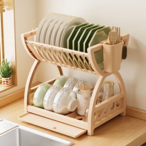 A multi-layer kitchen sink organizer rack sitting on a countertop, neatly holding bowls, chopsticks, and hanging utensils.