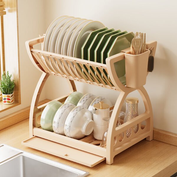 A multi-layer kitchen sink organizer rack sitting on a countertop, neatly holding bowls, chopsticks, and hanging utensils.